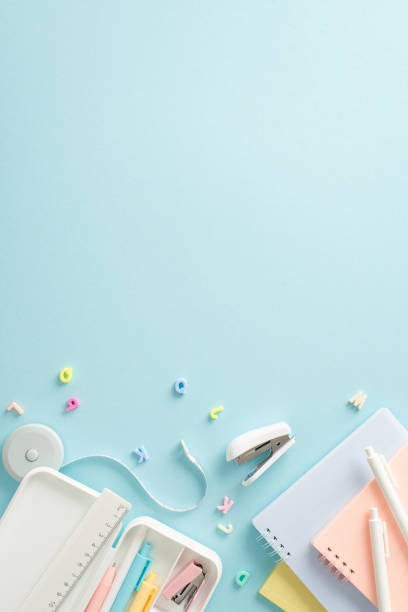 istock Enhance your academic success with captivating top vertical view showcasing wide range of stationery and alphabet letters on blue isolated background. Utilize empty circle for text or advertisements 1534528738