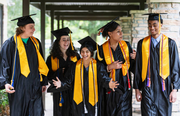 istock Five multiracial high school graduates standing outdoors 1534543097