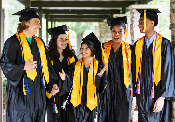 istock Five multiracial high school graduates standing outdoors 1534543103