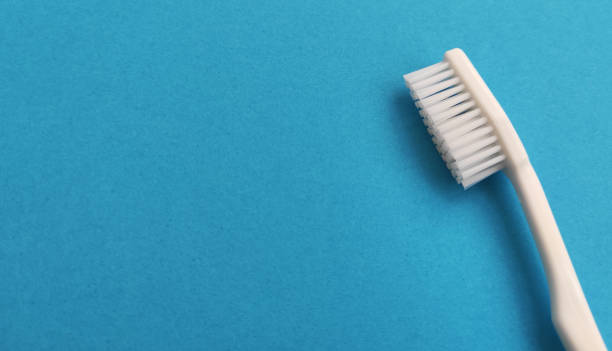 istock White toothbrush isolated on blue background 1534551127