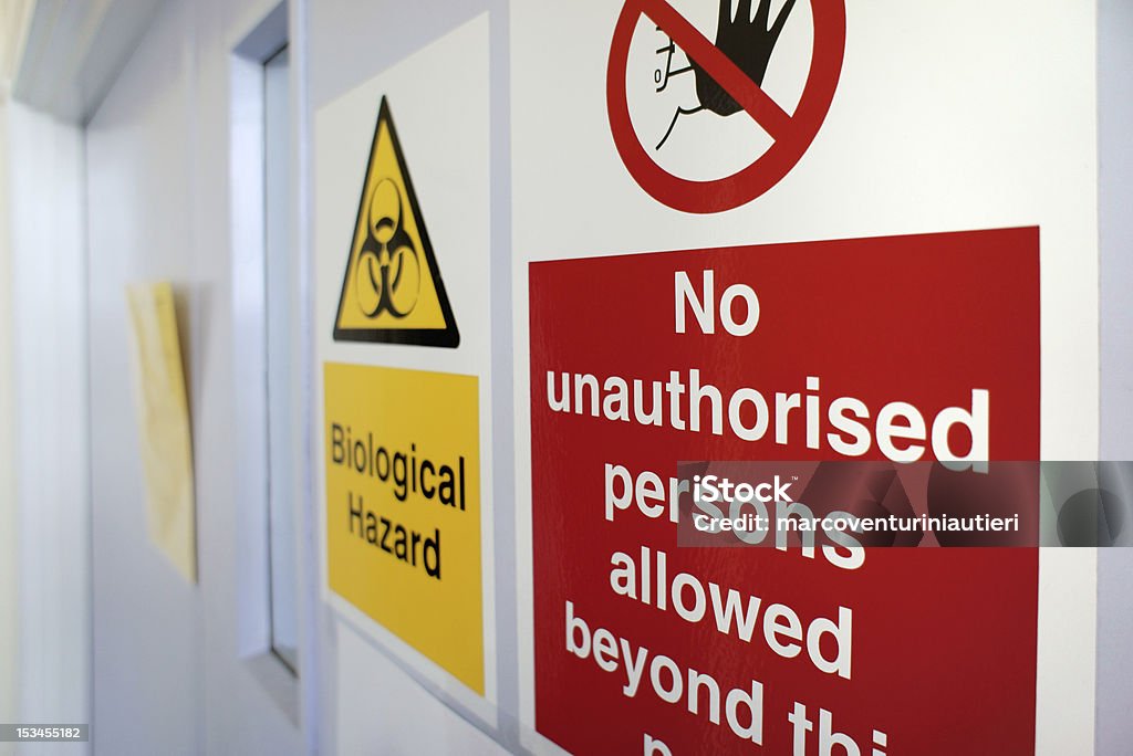 Biological hazard "Biological hazard" sign on a laboratory door. Selective focus. Hazard Sign Stock Photo