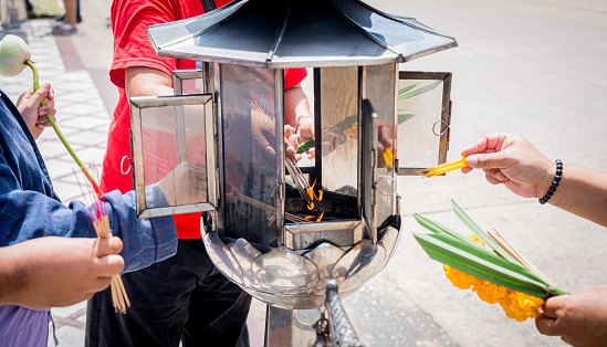 Ritual of burning incense sticks at the big Thai temple.