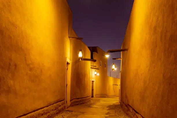Photo of Diriyah old town traditional street illuminated at night, Riyadh, Saudi Arabia