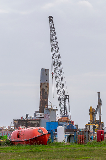 Cranes, lifeboats, life rafts, shipping equipment, at an old deserted port in Luisiana