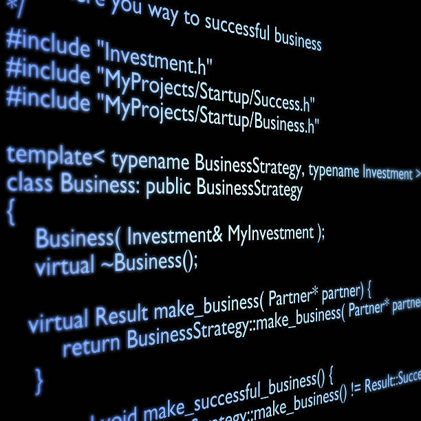 Close-up of C++ code in blue font over a black background stock photo