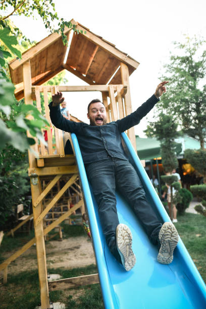 istock Baby Looking At Father Using Playground Slide Outside 1534668075