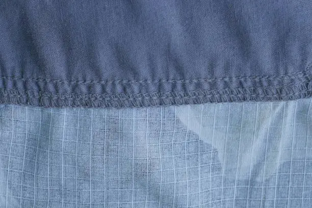 Photo of fabric texture of a piece of cotton clothing with a seams