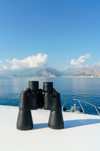 Modern binocular standing on the deck of the yacht