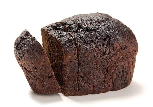 Black bread loaf closeup on white background