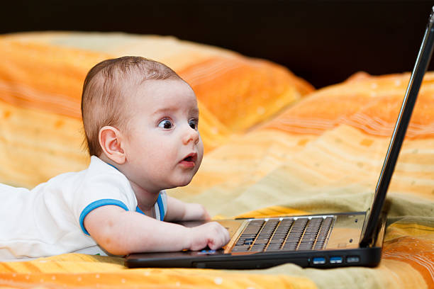 istock Baby boy with a laptop 153476616