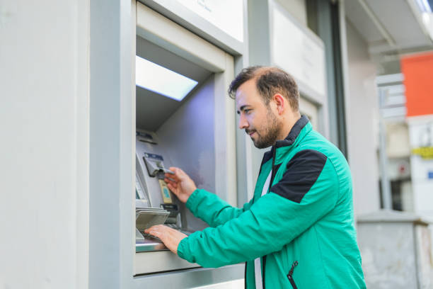 istock man withdrawing money from atm with card 1534767928