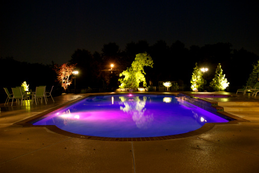 A night shot of a private residential swimming pool.