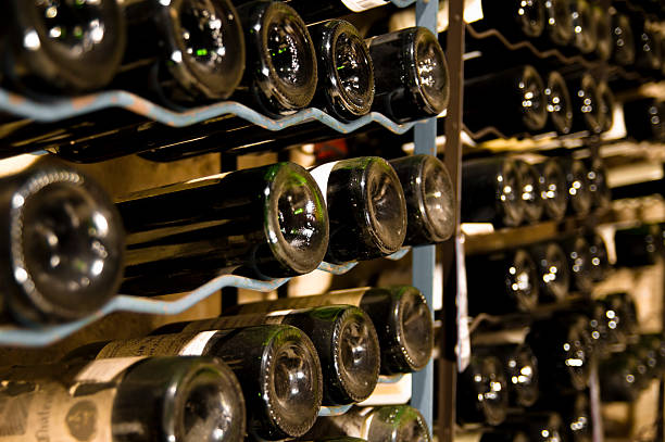Wine bottles stored on cellar shelves stock photo
