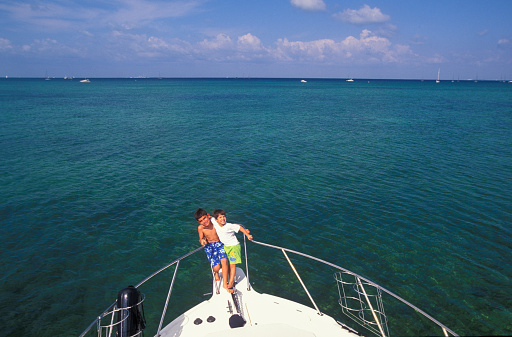 Two kids having fun on a boat, Florida Keys, USA
