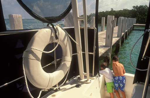 Two boys in the prow of the boat, Florida Keys, USA