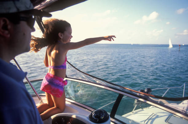 Father and daughter sailing on a yacht, South Florida, USA