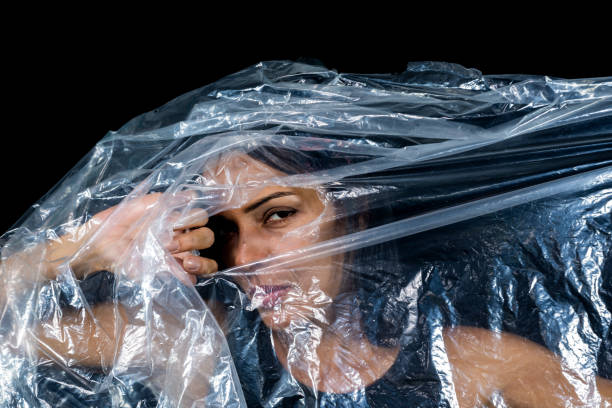 istock A woman with a plastic bag over her head looking through a hole. Protest against the use of plastic in the world. Environmental problems. 1534809134