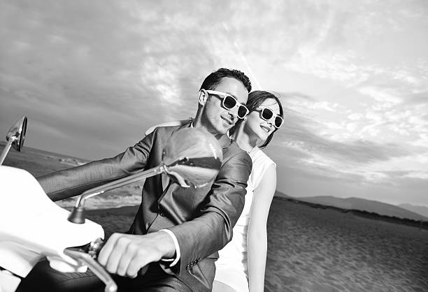 istock just married couple on the beach ride white scooter 153481616