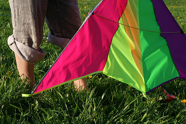 girl with ranbow kite stock photo