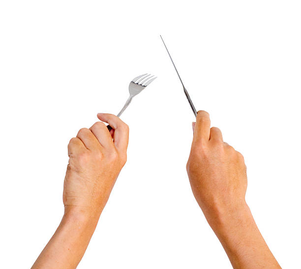 hands holding knife and fork stock photo