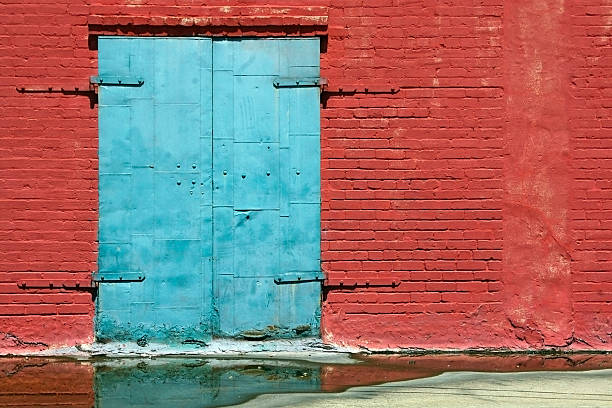 Old Blue Door with Red Brick Wall stock photo