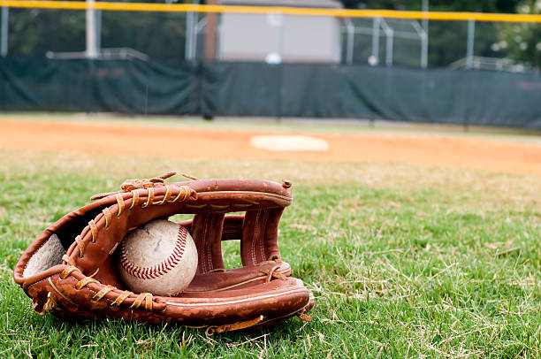 istock Old Baseball and Glove on Field 153483640