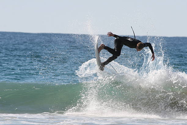 istock Surfer busts out of the wave and gets some air 153484827