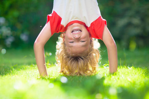 istock Little boy hanging upside down. Handstand exercise 1534850597
