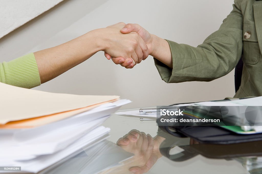 Handshake Two business women shake hands. Adult Stock Photo