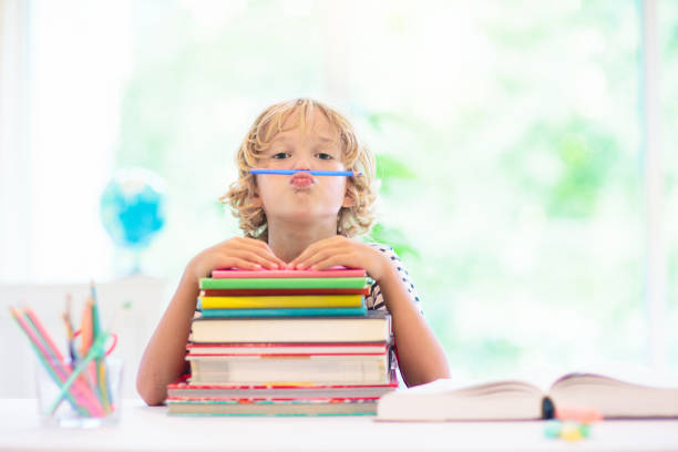 istock Child with books doing homework after school. 1534855550