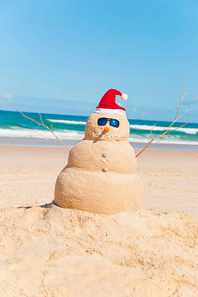 Heat Resistent Snowman Sunbathing On Beach stock photo
