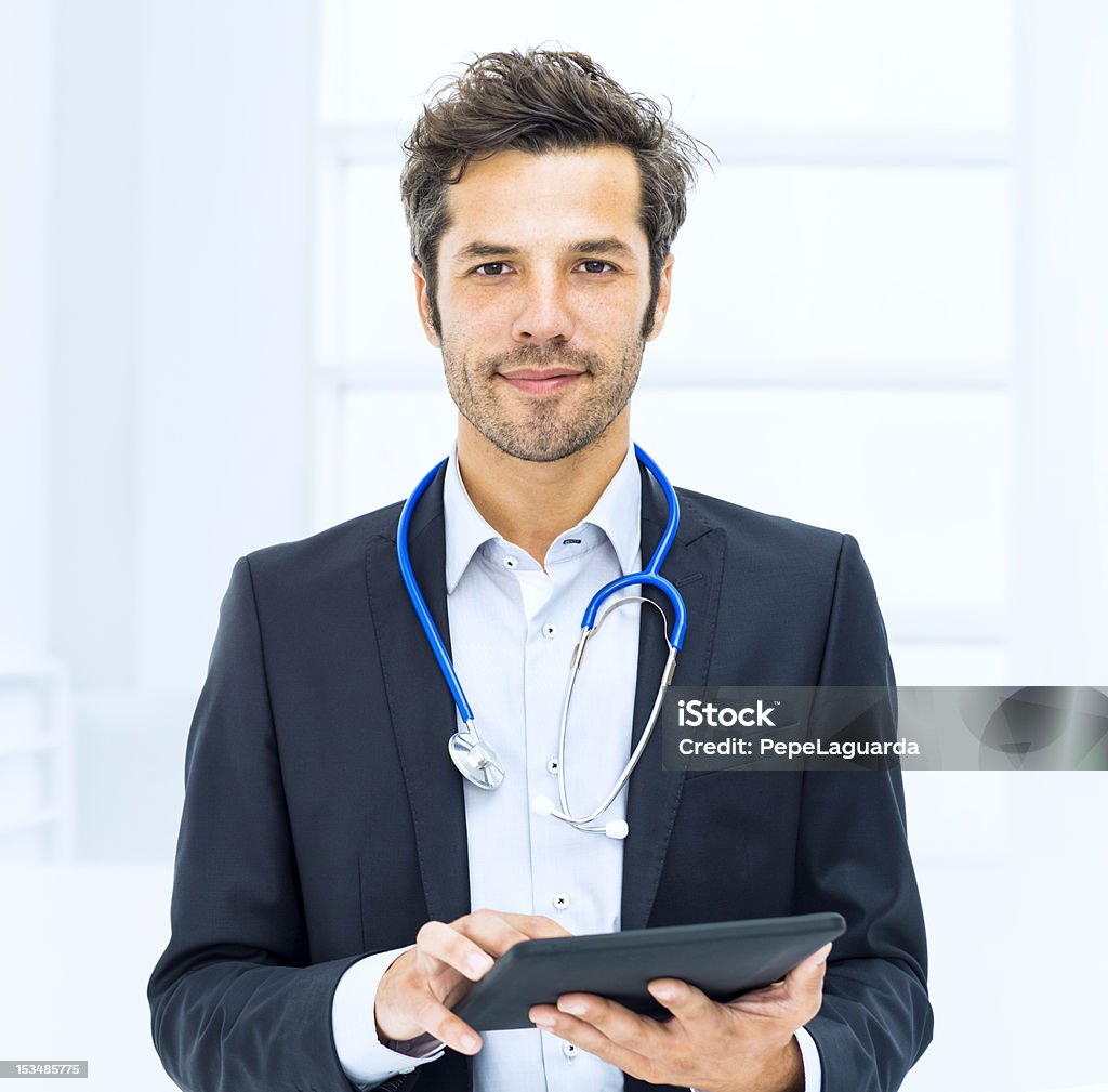 Doctor using digital tablet in hospital Doctor Stock Photo