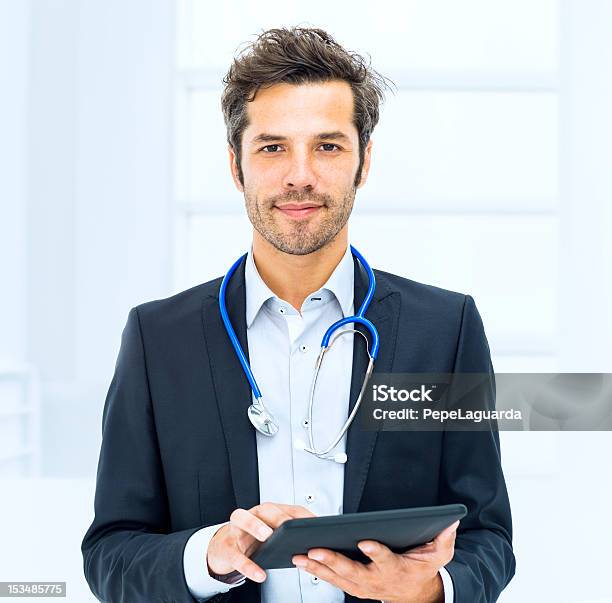 Doctor Using Digital Tablet In Hospital Stock Photo - Download Image Now - Doctor, White Background, Digital Tablet