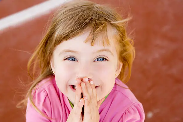 Photo of blond happy smiling little girl excited laugh