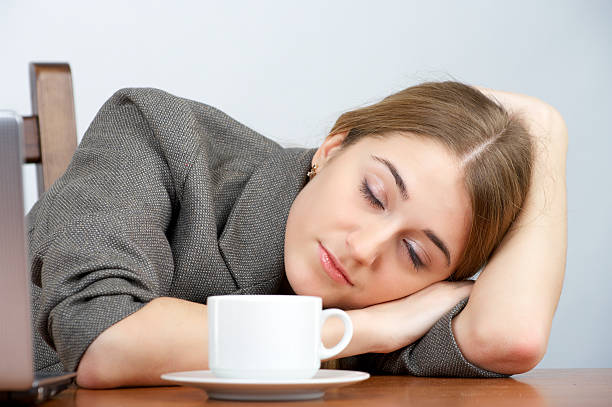 istock Beautiful businesswoman sleeping at her workplace 153487626