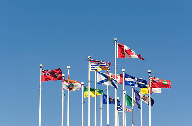 Flags flying in the Wind Flags flying in the Wind - Flags of the Canadian Provinces on Canada Place, Vancouver, British Columbia, Canada new brunswick canada photos stock pictures, royalty-free photos & images