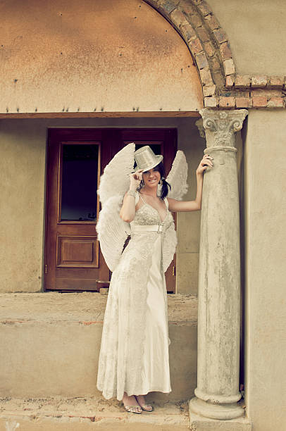 istock Beautiful sexy bride in white standing against building pillar 153491266
