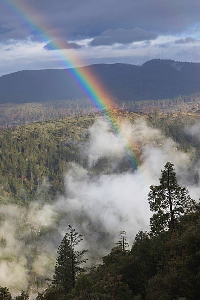 Rainbow over Yosemite stock photo