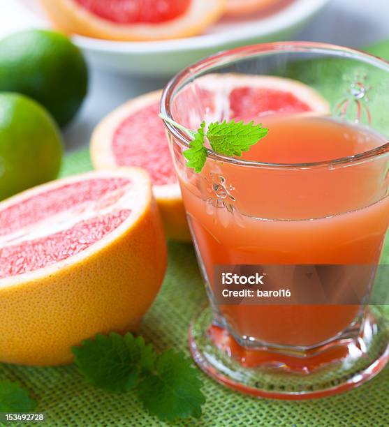Glass Of Pink Grapefruit Juice With Lemon Mint Stock Photo - Download Image Now - Citrus Fruit, Close-up, Drink