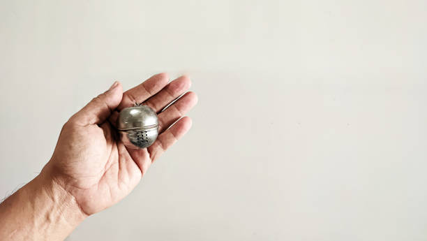 istock Male hand is holding a stainless steel tea strainer 1534937120