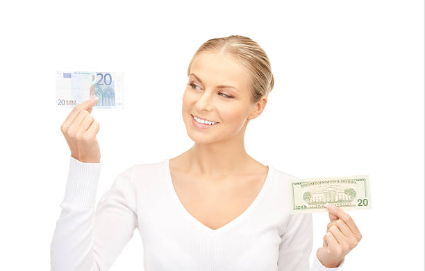 istock woman with euro and dollar money notes 153494276