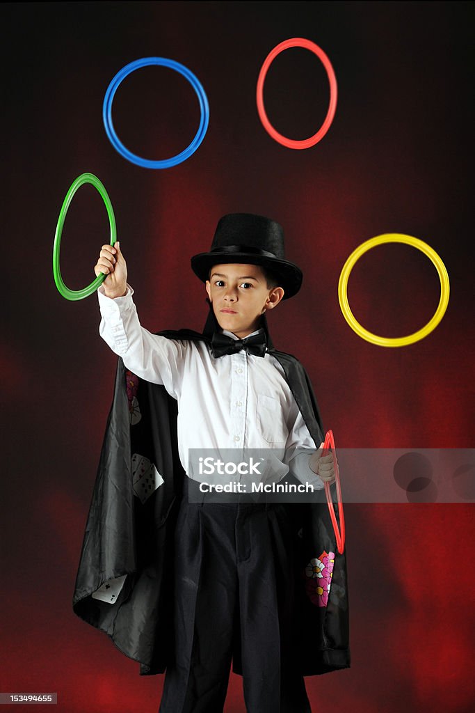 Juggling Magician A young magician juggling colorful rings.  Some motion blur on the rings. Juggling Stock Photo