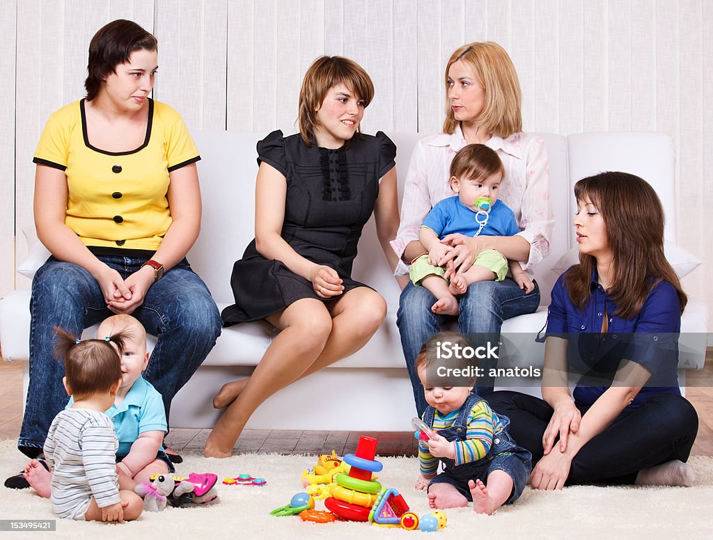 Women and their children Women talking, their children playing 12-17 Months Stock Photo