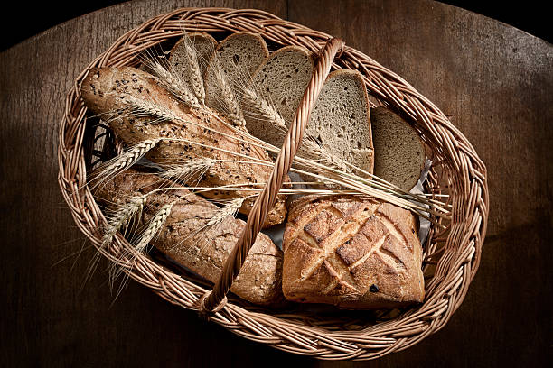 Basket with types of Bread loafs and wheat stock photo