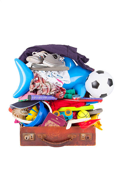 summer vacation or holiday suitcase really packed, cannot close stock photo