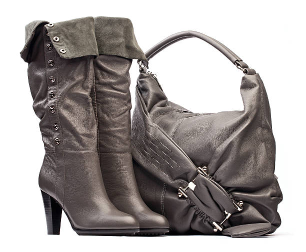 istock Gray female high-heeled boots and bag on white 153496738
