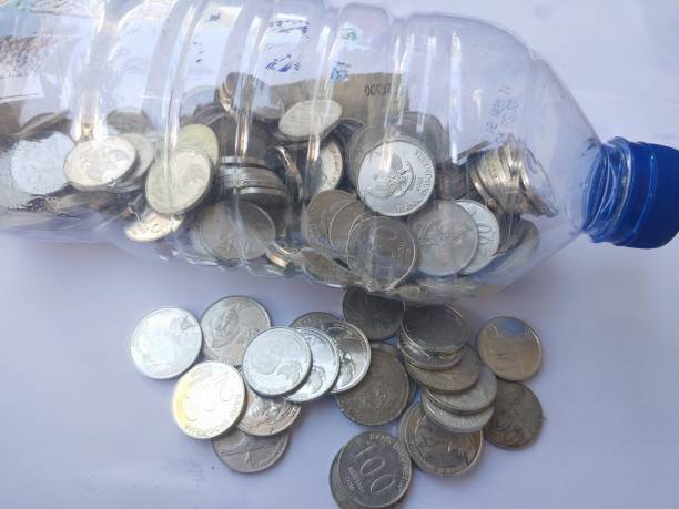 istock Coins in the plastic bottle on white background 1534972859