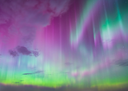 A G4 aurora storm fills the sky with beautiful colors and pillars.