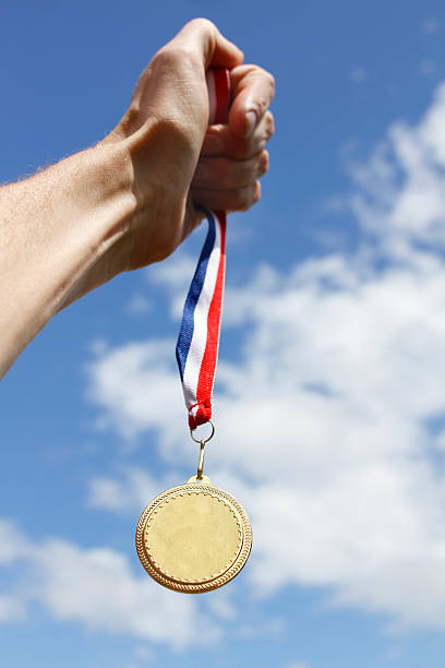 istock Winning athlete holds . Gold Medal 153498448