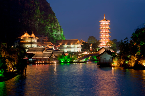 Mulong Pagoda also known as the Mulong Tower reflected in the Mulong Lake,  Mulong Lake Park, Guilin, China